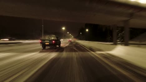 pov shot traveling quickly along a snowy highway in helsinki