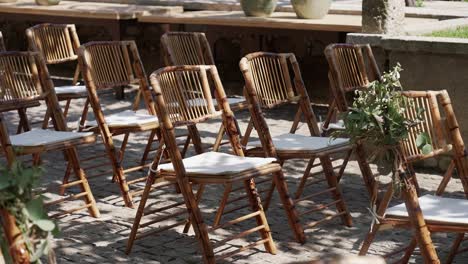 outdoor wedding setup with wooden chairs in european village courtyard