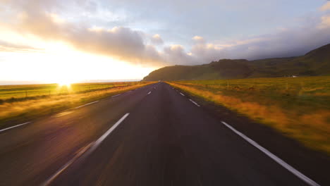 Blick-Auf-Die-Straße-Beim-Fahren-In-Island,-Erstaunlicher-Sonnenuntergang.-Schnelle-Geschwindigkeit