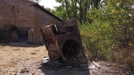 very old washing machine next to a wáter mill