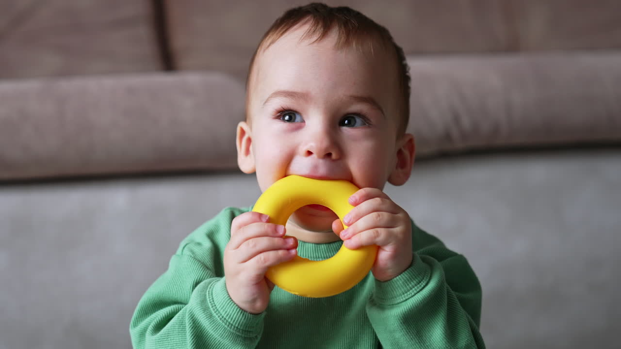 Baby playing with a yellow ring