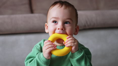 baby playing with a yellow ring