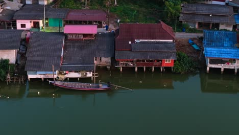 aerial view of a river village with houses on stilts