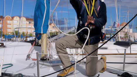 slow motion shot of a man throwing rope towards a dock to secure his boat