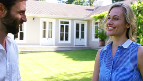 man giving the house''s keys to a smiling woman