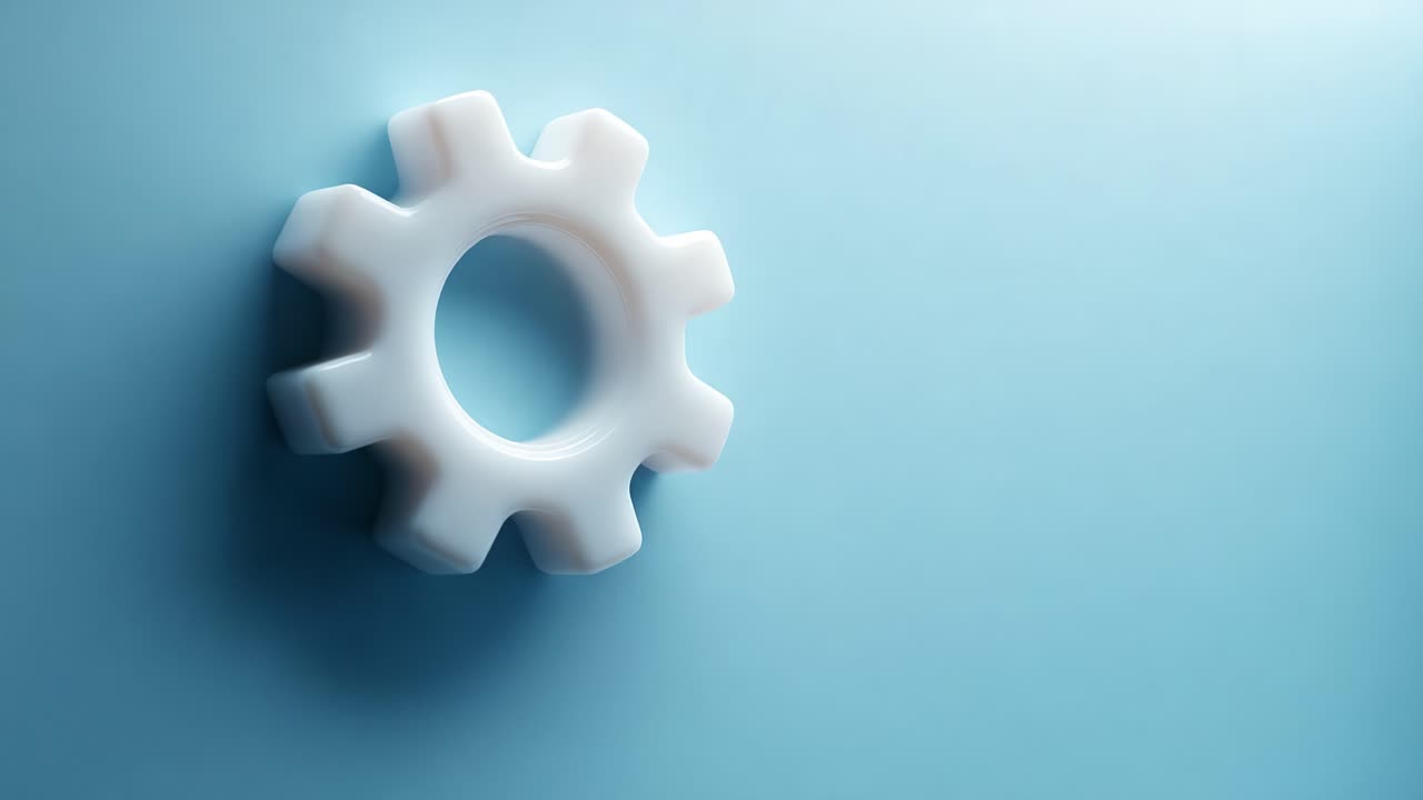 A close-up view of a white gear resting against a soft blue background, showcasing the detailed structure and contours of the gear in a minimalist aesthetic