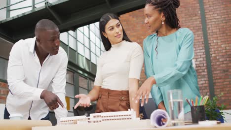 Happy-diverse-architects-looking-at-architectural-models-at-office