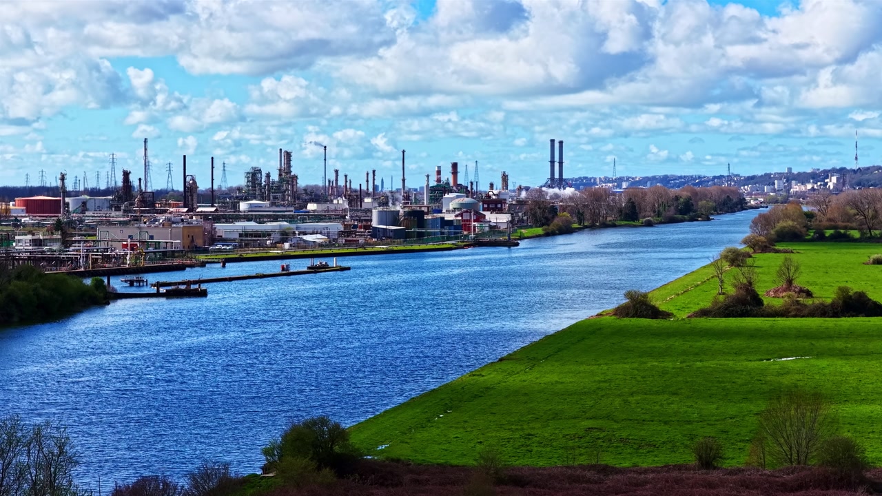 Seine River Between Lush Green Fields And Industrial Refinery In Le Havre, France. timelapse