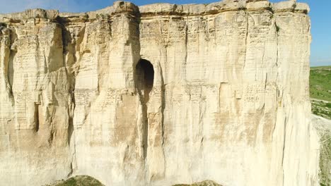 high white cliff with hole