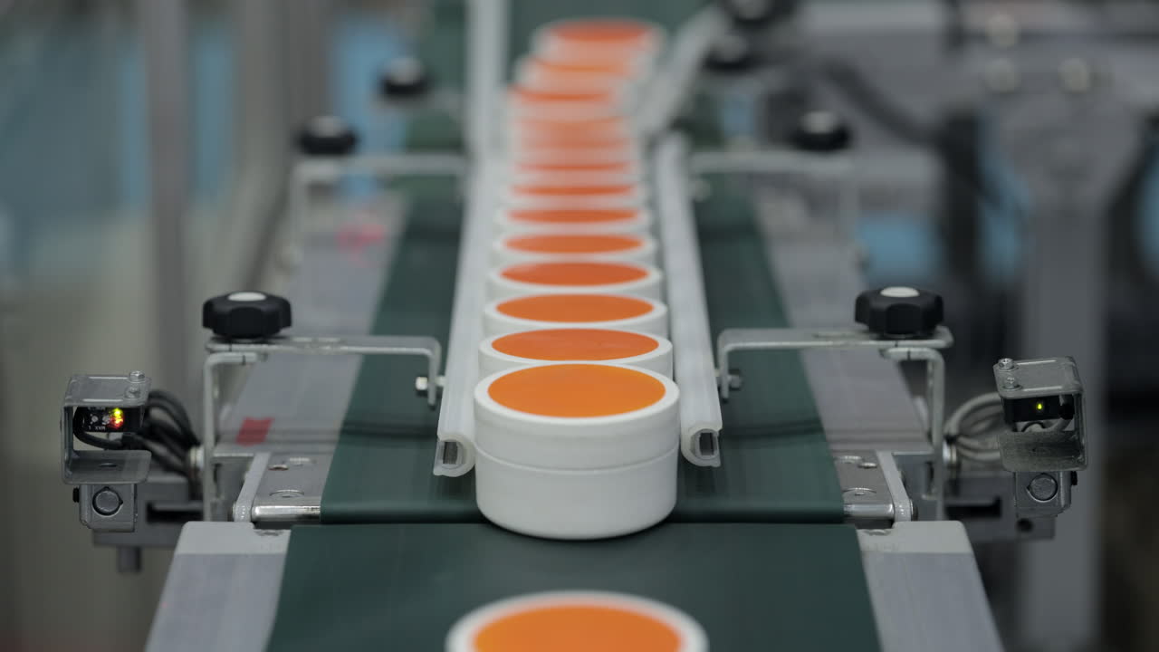 Cosmetic jars on a conveyor belt