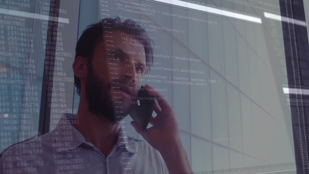 Talking on phone, man with computer code overlaying glass office wall