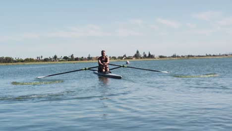 senior caucasian man rowing boat on a river