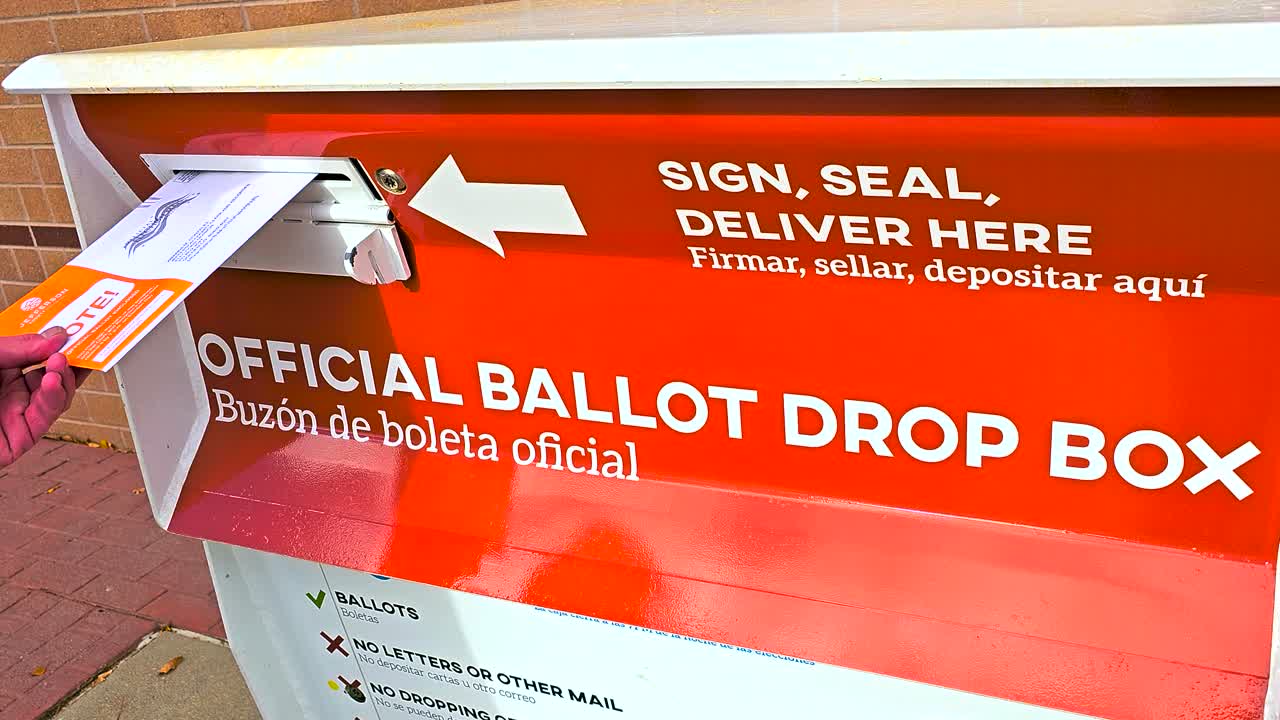 Hand placing a ballot envelope into an official drop box, symbolizing civic duty, democracy, freedom, election integrity, safety, responsibility, and secure participation. Closeup