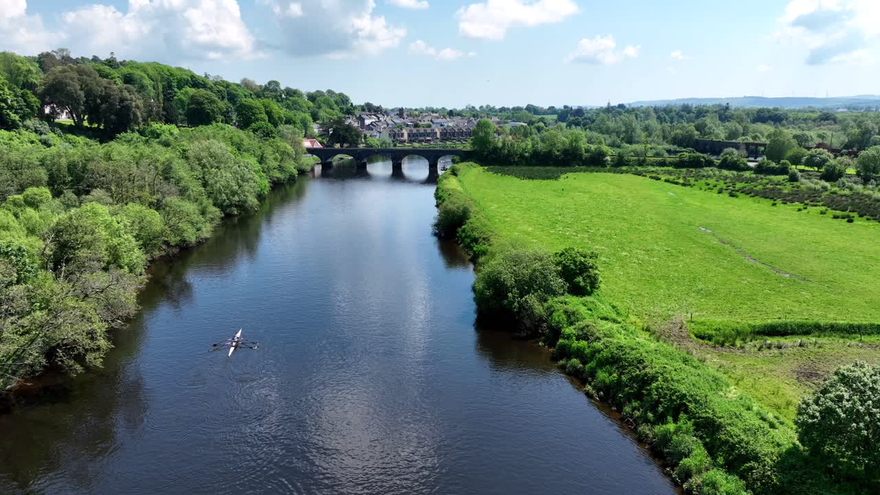 Scenic river landscape with bridge and rowing boat