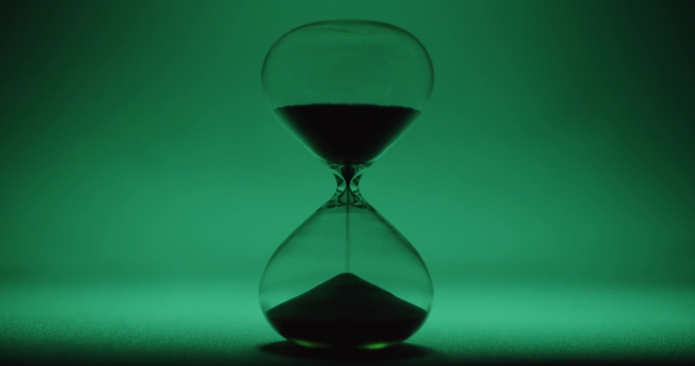 Hour glass on turquoise background