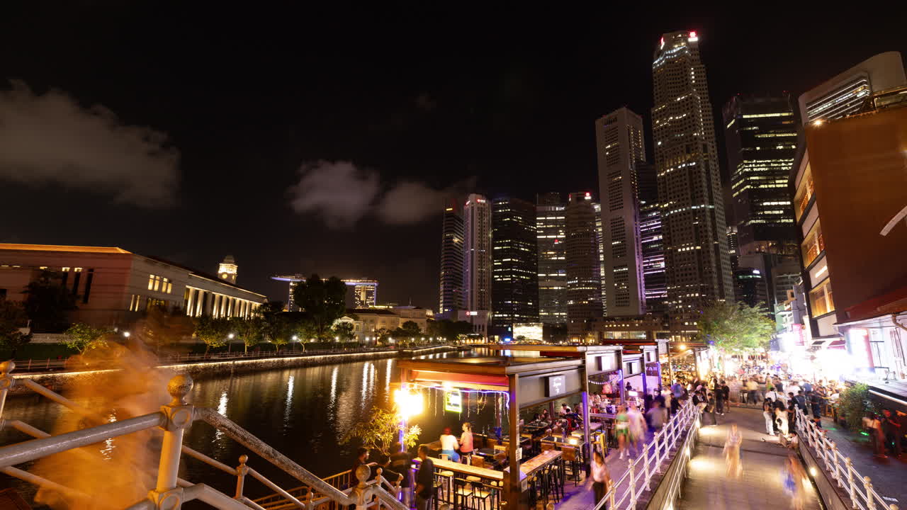 SINGAPORE - 5 MARCH 2025 : timelapse of the singapore central business district skyline reflected in the river at night