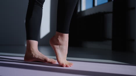 woman doing yoga pose on mat