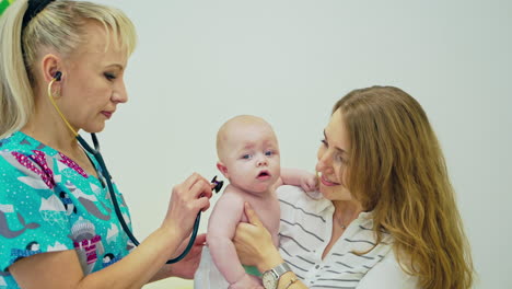 doctor examining baby in hospital. doctor pediatrician and baby patient in clinic