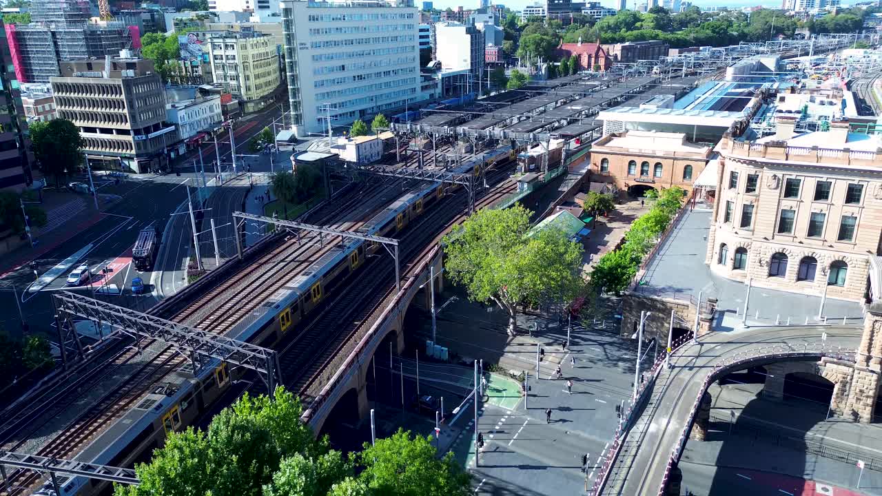 Drone aerial landscape of commuter train on railway tracks line entering Sydney's Central station yard platform city Australia transport urban travel tourism