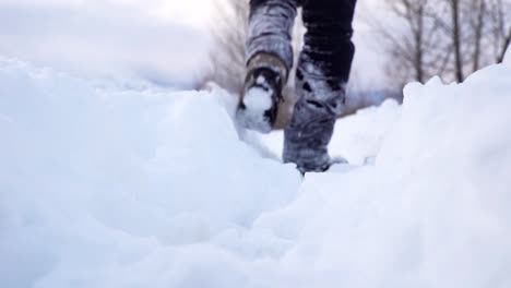 low angle shot of walking on snow in slow motion
