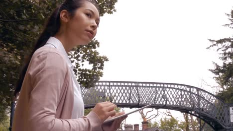 businesswoman using tablet on train platform