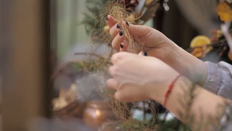 florist at work. how to make christmas wreath with floral arrangement. step by step, tutorial