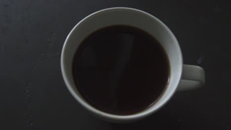 a fresh cup of dark roast coffee brewed in the morning