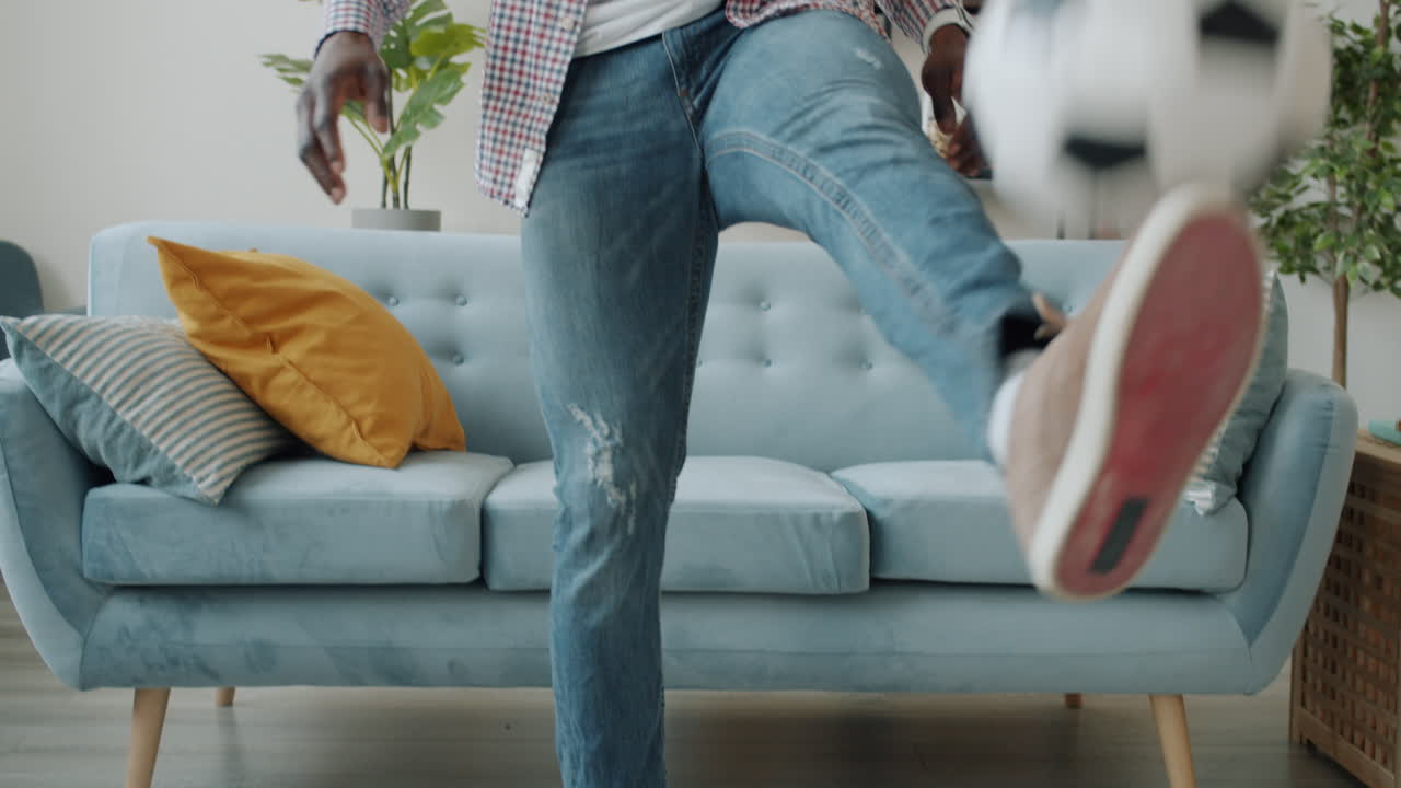 Man Dancing in Living Room and Man Listening to Music with Soccer Ball
