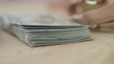 stack of cash on a wooden surface