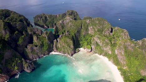 aerial drone video of phi phi leh with maya bay and pileh lagoon, krabi province, thailand. aerial top view of amazing tropical island with turquoise water and white beach, famous travel destination.