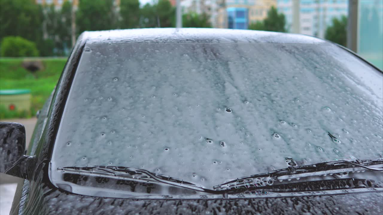Car being washed with soap foam