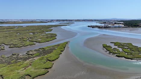 Drone-shot-flying-over-the-river-delta-south-of-Almada,-Portugal
