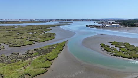 drone shot flying over the river delta south of almada, portugal