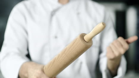 Chef-hands-rolling-roller-in-kitchen