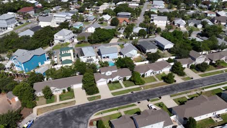 dynamic drone movement over the quiet residential district with white houses and green lawns, panama city beach, florida, usa