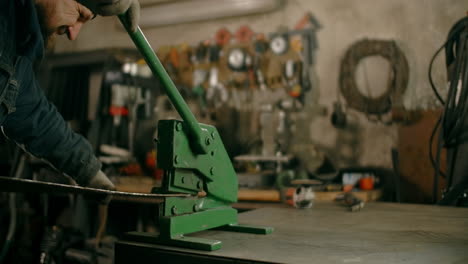 metalworker using a metal shear