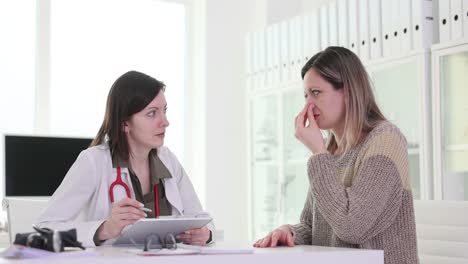 female patient consulting a doctor about discomfort