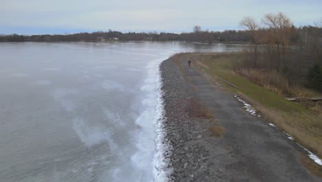 aerial drone following a young woman on a winter day