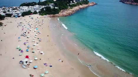 a static aerial view of a yacht at the shek o beach in hong kong as public beaches reopening, after months of closure amid coronavirus outbreak, to the public