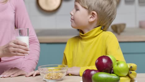 child having breakfast with his mother
