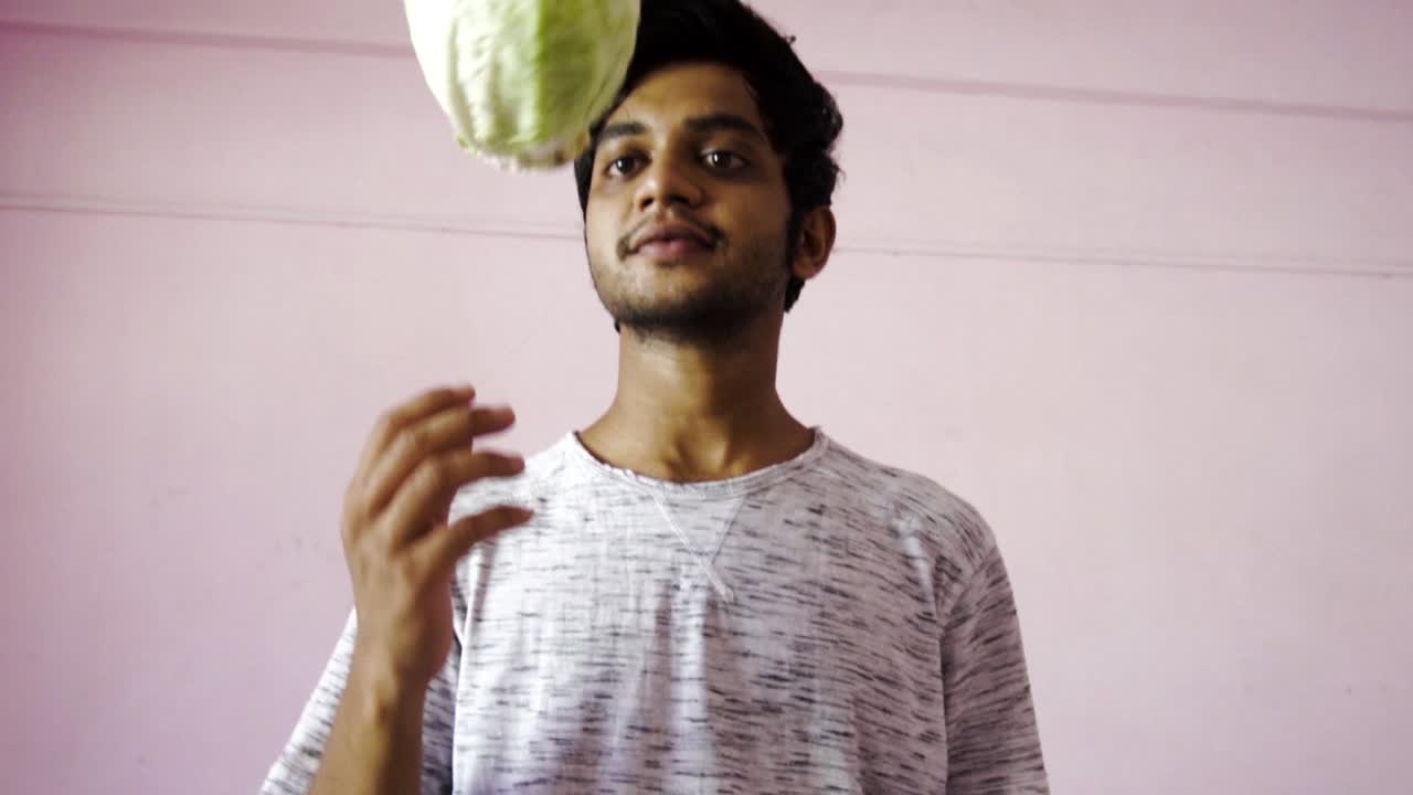 Young man spinning cabbage for salad