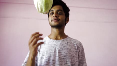 young man spinning cabbage for salad