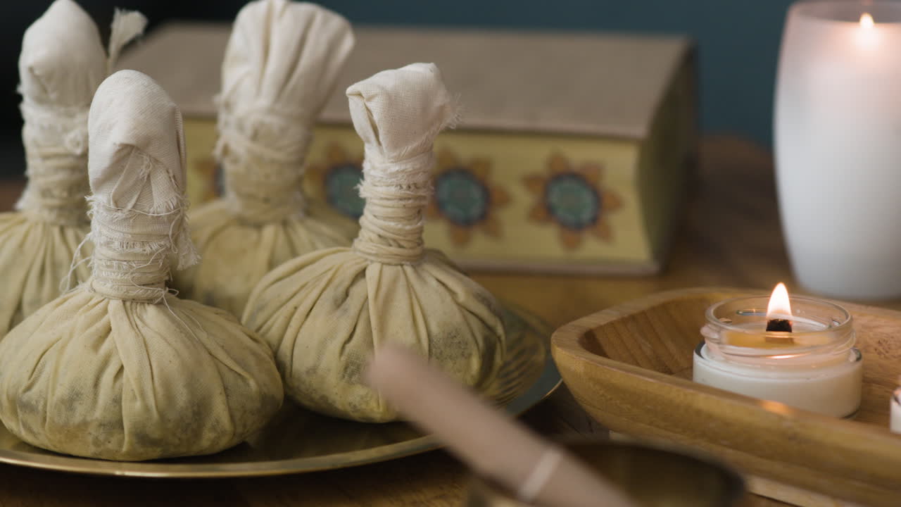 Spa Still Life with Herbal Compresses and Candles