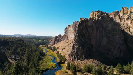 river and caldera in smith rock state park, drone track left, oregon