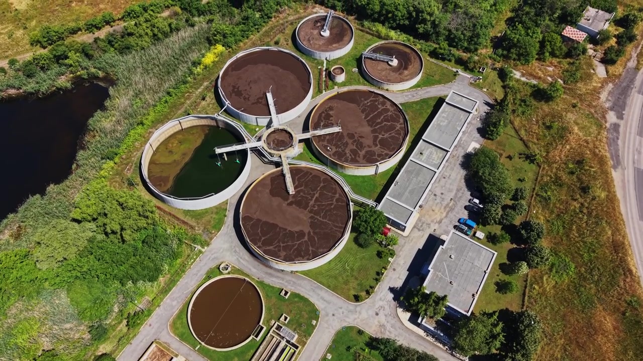 Water treatment facility near a river shows various processes in action