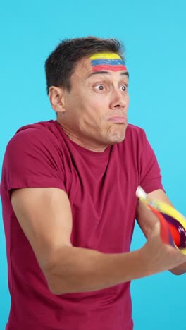 man cheering for venezuela, angry with the decision of referee