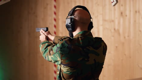 joyous soldier training with firearm exults after accurately hitting bullseye