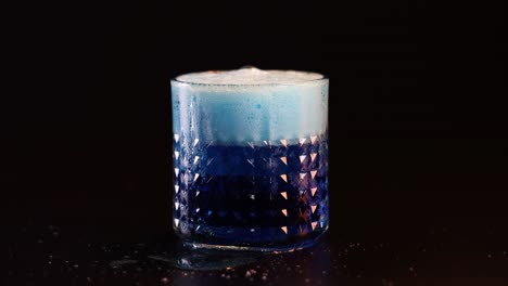 effervescent blue drink in a textured glass