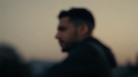 athlete staring into the distance during golden hour, slowly looking around. the scene captures a moment of focus and determination against a backdrop of warm, serene light