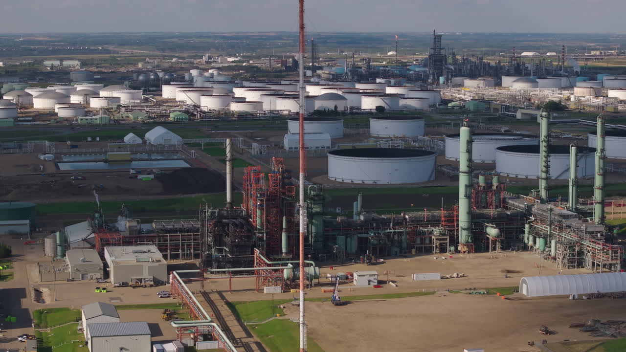Vast industrial refinery, complex machinery, daytime, energy concept